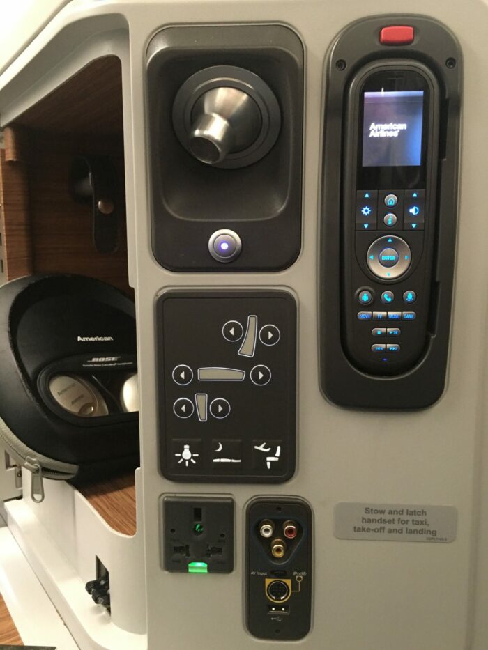 american airlines business class boeing 777 300er los angeles lax to london heathrow lhr headphones remote controls 700x933