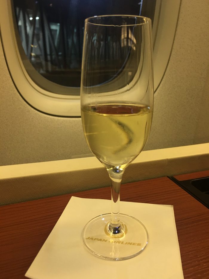 jal first class boeing 777 300er tokyo haneda hnd to san francisco sfo champagne 700x933