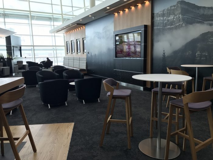 aspire lounge transborder departures calgary airport yyc seating tables 700x525